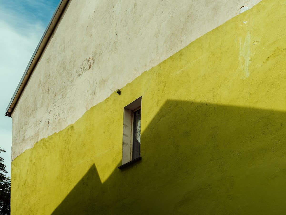 a yellow and white building with a window