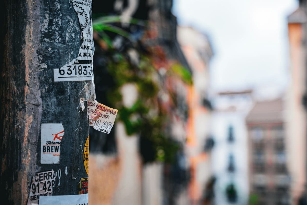 a close up of a pole with a bunch of stickers on it